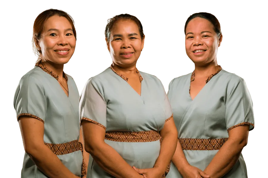 Certified Thai massage therapists at ApaThai Almaty, wearing traditional spa uniforms and welcoming guests.